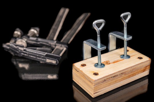 Bonding two pieces of raw plywood in carpentry clamps. Minor carpentry work in a home workshop.