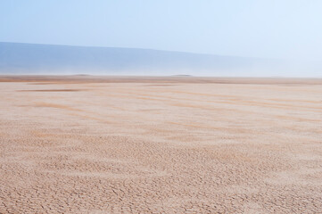 Fototapeta na wymiar Sandstorm on the Lac Iriki salt lake / Sandstorm in the Sahara, on the Lac Iriki salt lake, Morocco, Africa.