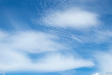 Altostratus clouds against a blue sky.