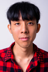 Portrait of young handsome Asian hipster man