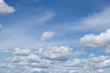 Cumulus clouds against a blue sky.