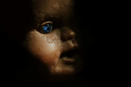 close up of a vintage baby doll, in the shadow