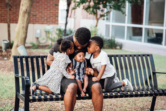 Father kissing kids