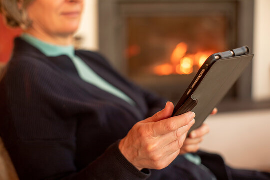 Woman reading book from an electronic tablet
