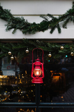 Red kerosene lamp on black background.