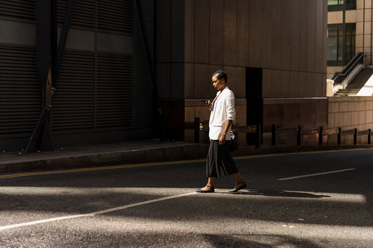 Young Businesswoman going at work, walking during a sunny day.