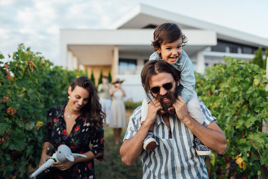 Young Family Walking In The Vineyards