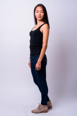 Full body shot of young beautiful Asian woman