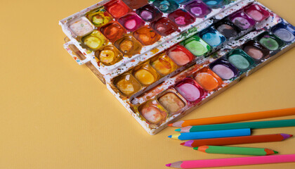 colourful watercolor kit on white background representing creative hobby concept