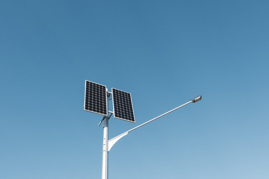 Two solar panels on a high pillar with flashlight