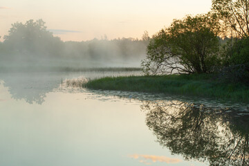 River in morning covered with fog