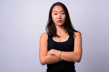 Obraz premium Portrait of young beautiful Asian woman against white background