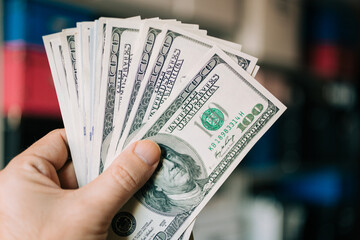 Close Up Of hands with one Hundred Dollar Bills