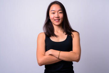 Portrait of happy young beautiful Asian woman