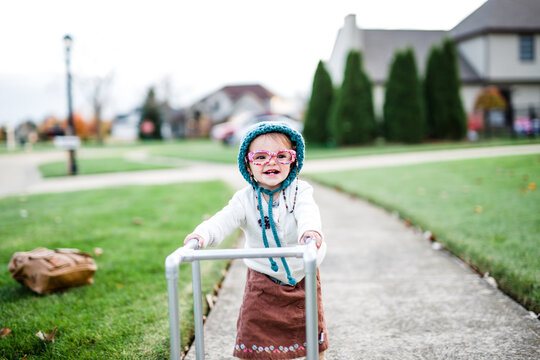 toddler girl dresses up as old lady with walker for Halloween