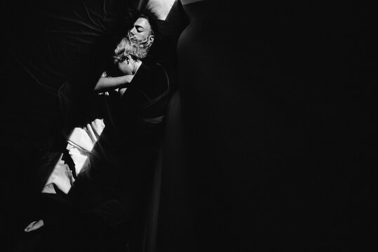 Couple in love sleeping in the bed in dark room
