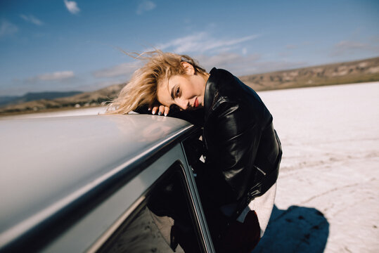 Portrait Of Beautiful Young Woman With Blonde Hair In Black Leather Coat