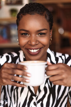 Portrait of a afro woman drinking a coffee in a coffee shop