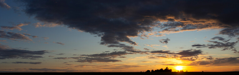 Obraz premium Panorama. Landscape with bloody sunset. Fantastic skies on the planet earth. Purple clouds. Tragic gloomy sky. Twilight.