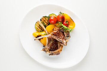 Modern French cuisine: Roasted Lamb neck & rack served with carrot, yellow curry and lamb sauce.