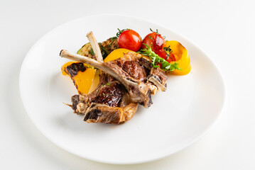 Modern French cuisine: Roasted Lamb neck & rack served with carrot, yellow curry and lamb sauce.