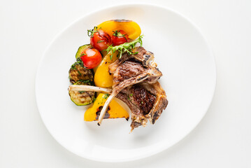 Modern French cuisine: Roasted Lamb neck & rack served with carrot, yellow curry and lamb sauce.