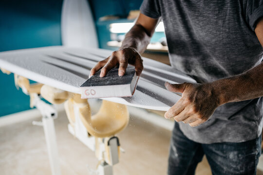 Anonymous shaper making a surfboard
