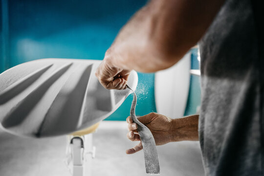 Anonymous shaper making a surfboard