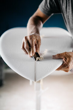 Anonymous shaper making a surfboard