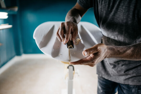 Anonymous shaper making a surfboard