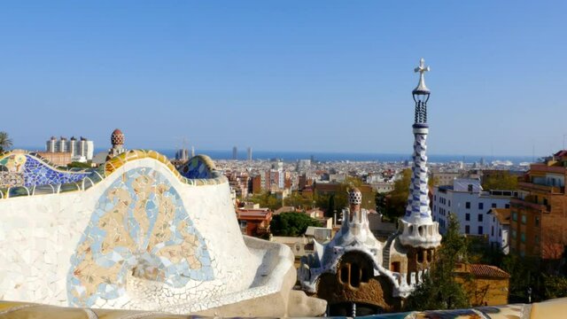 Ceramic tiles, houses in Antoni Gaudi's Park Guell and view to Barcelona, Spain