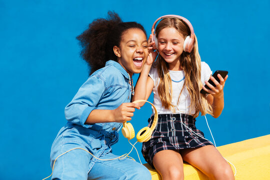 Excited girls listening to music together