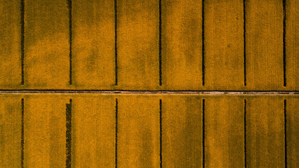 Drone shot of a gravel road in the fields of Rape