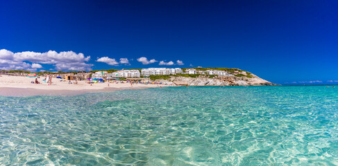 CALA MESQUIDA, MALLORCA, SPAIN - 19 July 2020: People enjoying beautiful sandy beach of on Mallorca, Mediterranean Sea, Spain.