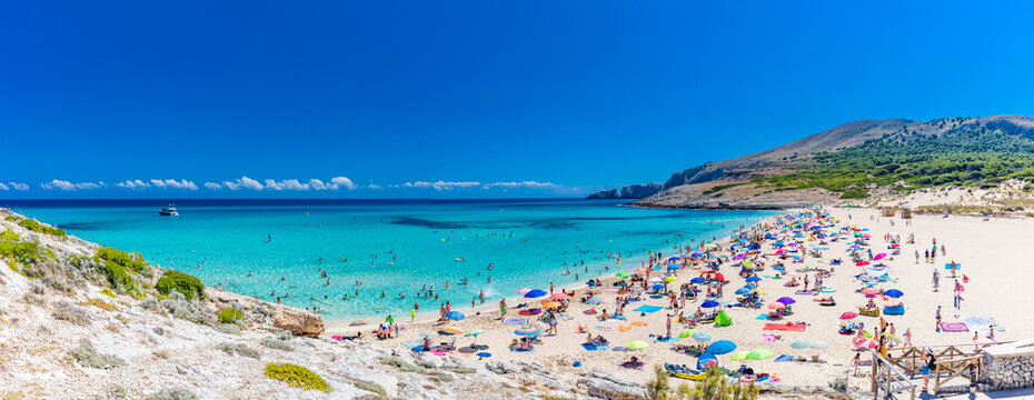CALA MESQUIDA, MALLORCA, SPAIN - 19 July 2020: People enjoying beautiful sandy beach of on Mallorca, Mediterranean Sea, Spain. - Powered by Adobe