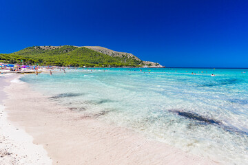 CALA AGULLA, MALLORCA, SPAIN - 21 July 2020: People enjoying summer on the popular beach on Mallorca,  Balearic Islands.