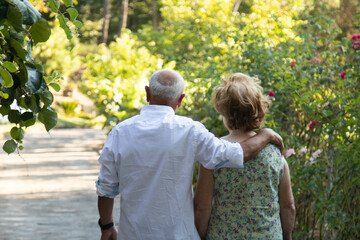 Fototapeta premium senior couple walking embraced outdoors
