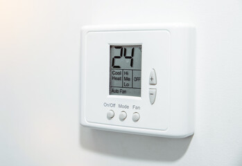 Air conditioner in the room. The concept of cooling the apartment on warm days. White panel for temperature control in a room, office.