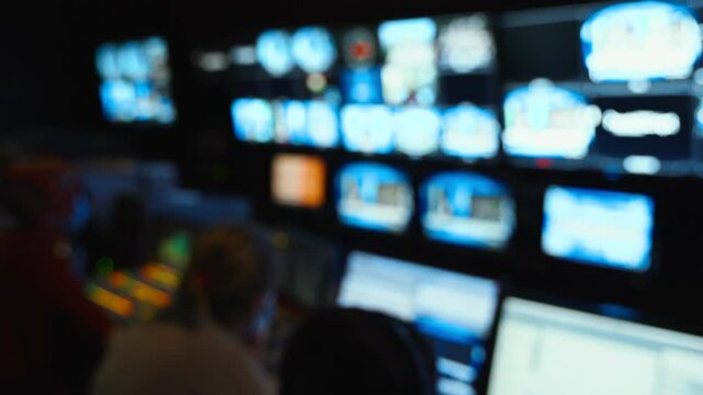 Professional sound engineer's console. Television Broadcast, working with video and audio mixer, control broadcast in recording studio. blurred background, monitors.