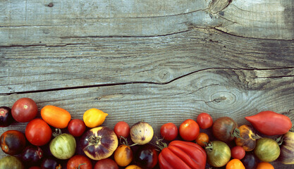 Tomatoes on a wooden surface, place for an inscription.
