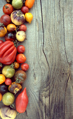 Tomatoes on a wooden surface, place for an inscription.