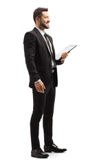 Obraz na płótnie Canvas Elegant man in a black suit holding a clipboard