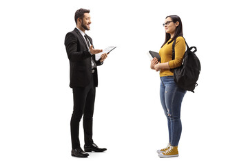 Businessman talking to a young lady with a backpack and a book