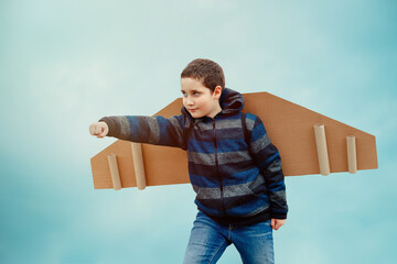 Funny boy play with toy plane. Concept of summer holidays and vacation