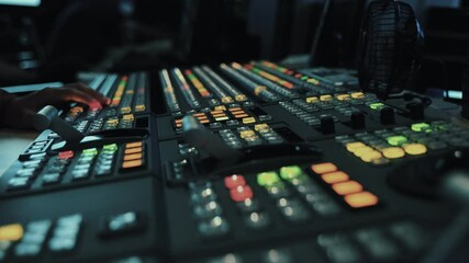 Broadcast Tv Studio Production - Vision Switcher Studio Director broadcast video mixer operation - Close-up of hand. Hands of a cinematographer who worked on the vision mixer, switch the TV panel.