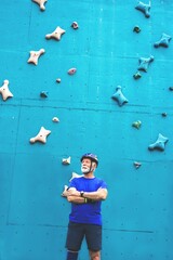 Senior sportsman in front of rock climbing wall