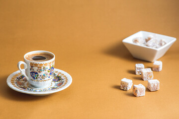 Turkish coffee and Turkish delight view over mono color minimal brown background