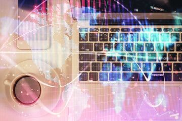 Business theme hologram drawings over computer on the desktop background. Top view. Multi exposure. Concept of international connections.