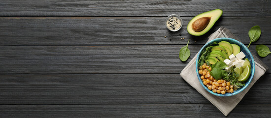 Delicious avocado salad and space for text on black wooden table, flat lay. Banner design