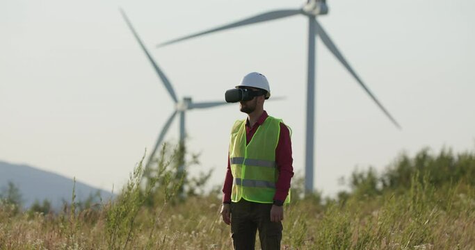 A young engineer in VR glasses unfolds the page, then